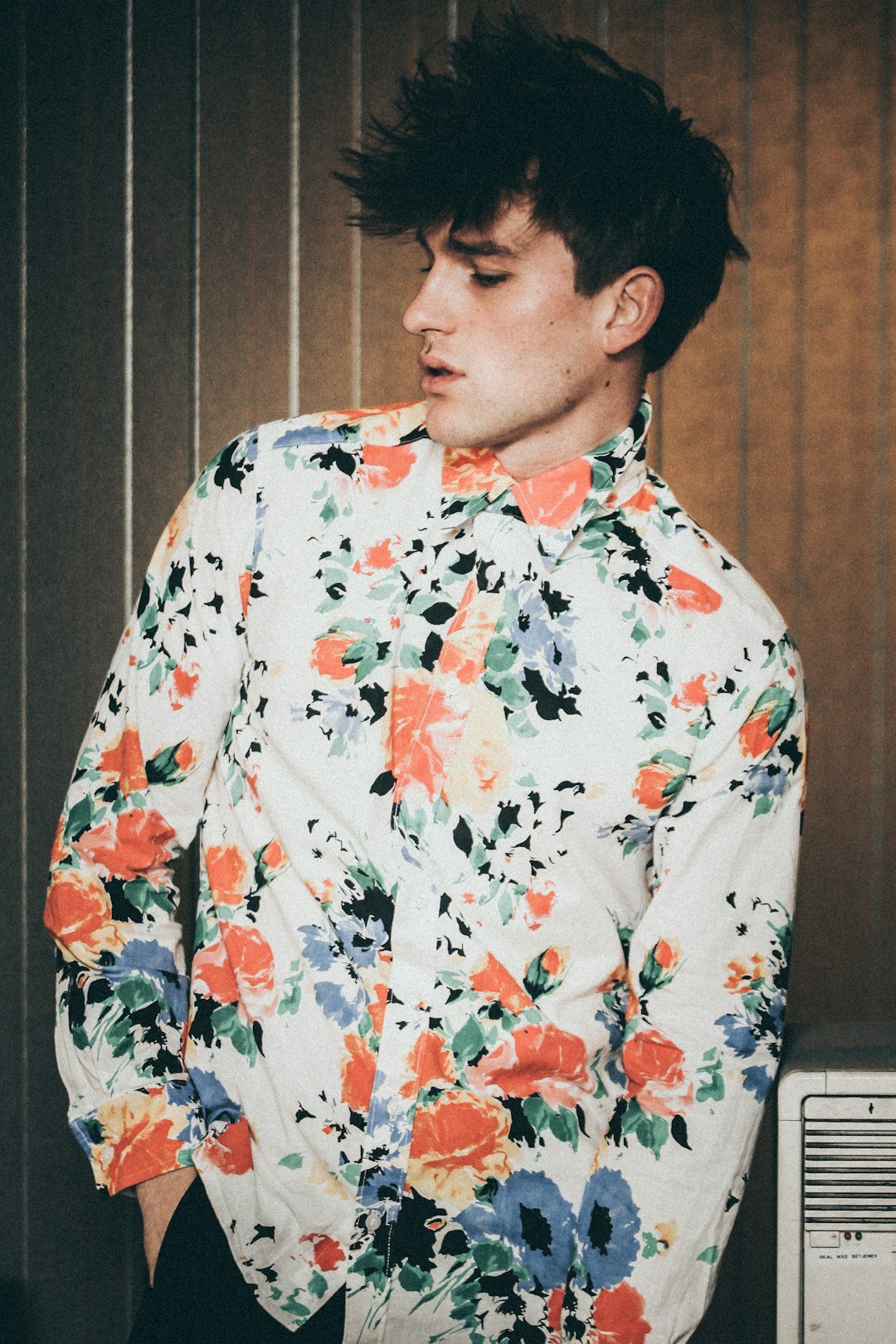 Portrait of a young Danish male photographer with a camera around his neck